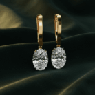 Planet Genesis - Emerald Tear Diamond Drop Earrings with large oval-cut diamonds in a tear drop design, set against dark textured fabric. - IGI-Certified Lab-Grown Diamonds