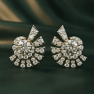 Planet Genesis - Gold sunburst earrings featuring central round diamonds and pavé-set diamonds in a geometric design, shown on a dark green background. - IGI-Certified Lab-Grown Diamonds