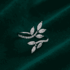 Planet Genesis - Diamond Vinea Arc Ring with marquise-cut diamonds in a leaf motif and pavé band, shown on dark green velvet. Premium fine jewelry. - IGI-Certified Lab-Grown Diamonds