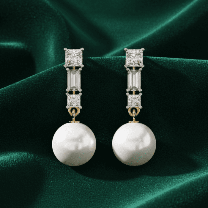 Planet Genesis - Pearl drop earrings with large round pearls, rectangular and square diamonds in gold, displayed on green satin fabric. Premium design. - IGI-Certified Lab-Grown Diamonds