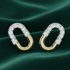 Planet Genesis - Crescent Duo Diamond Hoops on green fabric, elongated oval shape with diamond-set top half and smooth gold bottom in a modern design. - IGI-Certified Lab-Grown Diamonds