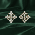 Planet Genesis - Diamond Clover Halo Earrings with a symmetrical floral motif and pavé diamonds displayed on rich dark green velvet fabric. - IGI-Certified Lab-Grown Diamonds