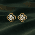Planet Genesis - Gold four-leaf clover stud earrings with five diamonds each, fine detailing, displayed on dark green velvet for a premium look. - IGI-Certified Lab-Grown Diamonds