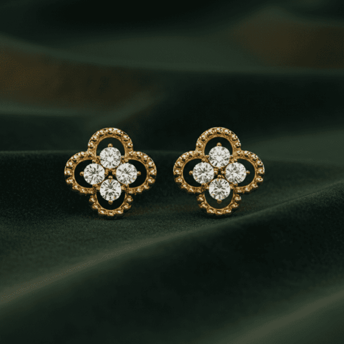 Planet Genesis - Gold four-leaf clover stud earrings with five diamonds each, fine detailing, displayed on dark green velvet for a premium look. - IGI-Certified Lab-Grown Diamonds