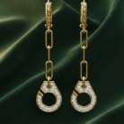 Planet Genesis - Geometric gold drop earrings with circular pendants, white diamonds, and rectangular chain links on dark green satin fabric. - IGI-Certified Lab-Grown Diamonds